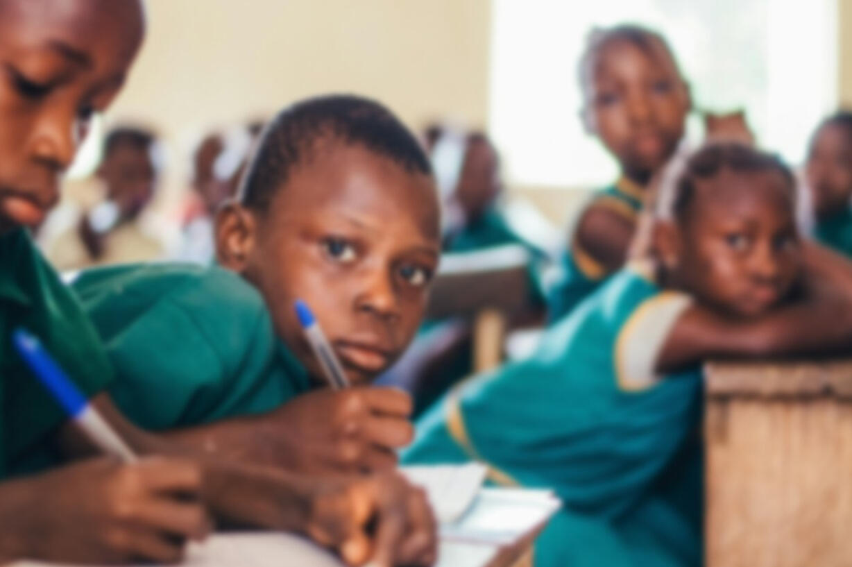 Learning together in a rural classroom Schoolchildren in uniform inside a rural classroom in Africa